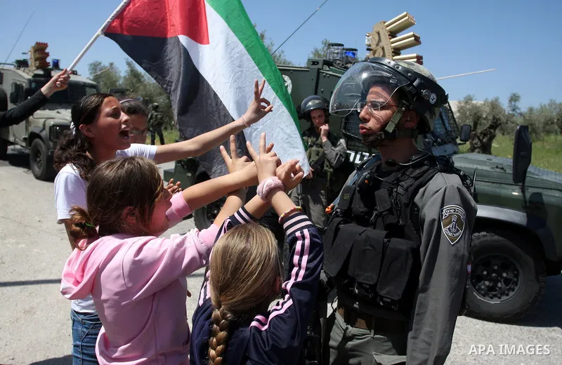 Palestinian and foreign activists confront Israeli soldiers during clashes in the weekly Friday demonstration in the West Bank village of Nabi Saleh, on April 20, 2012, against the construction of the nearby Jewish settl...