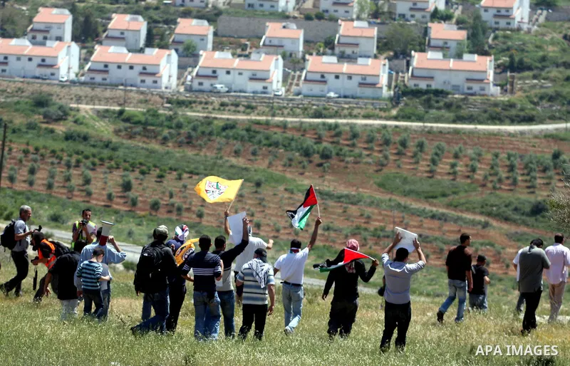 Palestinian and foreign activists confront Israeli soldiers during clashes in the weekly Friday demonstration in the West Bank village of Nabi Saleh, on April 20, 2012, against the construction of the nearby Jewish settl...