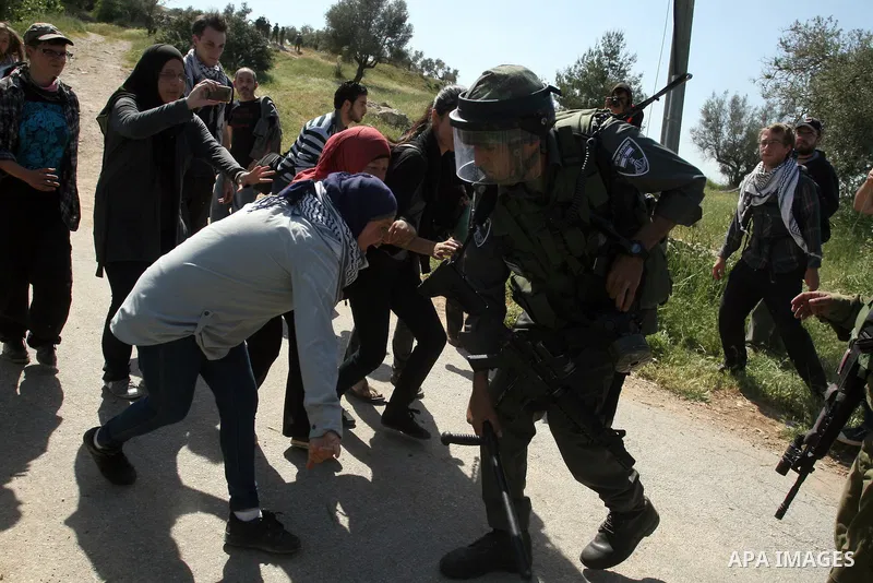 Palestinian and foreign activists confront Israeli soldiers during clashes in the weekly Friday demonstration in the West Bank village of Nabi Saleh, on April 20, 2012, against the construction of the nearby Jewish settl...