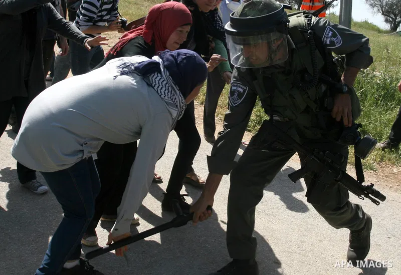 Palestinian and foreign activists confront Israeli soldiers during clashes in the weekly Friday demonstration in the West Bank village of Nabi Saleh, on April 20, 2012, against the construction of the nearby Jewish settl...