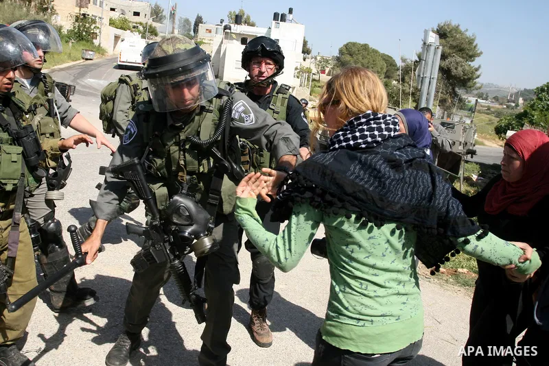 Palestinian and foreign activists confront Israeli soldiers during clashes in the weekly Friday demonstration in the West Bank village of Nabi Saleh, on April 20, 2012, against the construction of the nearby Jewish settl...