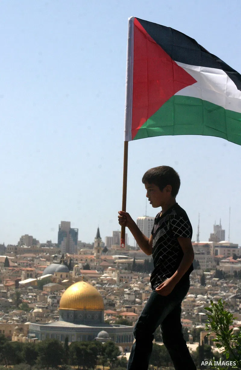 Palestinian demonstrate on the Mount of Olives, which overlooks the Dome of the Rock in the Al-Aqsa mosque compound, as they protest against the Jewish settlers who live in the Israeli annexed Arab East Jerusalem's a-Tur...