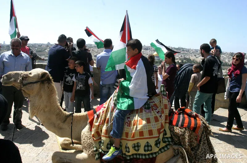 Palestinian demonstrate on the Mount of Olives, which overlooks the Dome of the Rock in the Al-Aqsa mosque compound, as they protest against the Jewish settlers who live in the Israeli annexed Arab East Jerusalem's a-Tur...