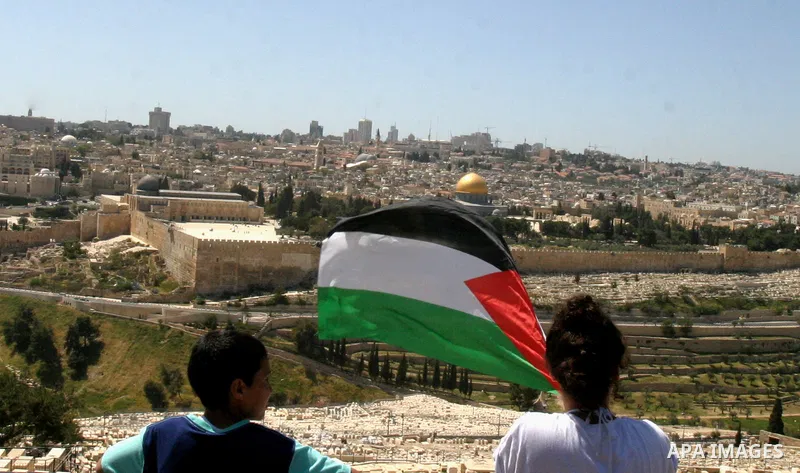 Palestinian demonstrate on the Mount of Olives, which overlooks the Dome of the Rock in the Al-Aqsa mosque compound, as they protest against the Jewish settlers who live in the Israeli annexed Arab East Jerusalem's a-Tur...
