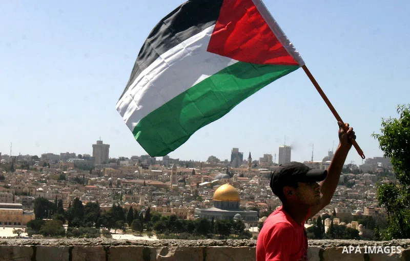 Palestinian demonstrate on the Mount of Olives, which overlooks the Dome of the Rock in the Al-Aqsa mosque compound, as they protest against the Jewish settlers who live in the Israeli annexed Arab East Jerusalem's a-Tur...