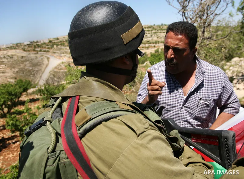 Israeli soldiers scuffle with Palestinian protesters during the weekly demonstration against settlement in the West Bank village Beit Ommar near Hebron.on April 21, 2012. Photo by Mamoun Wazwaz