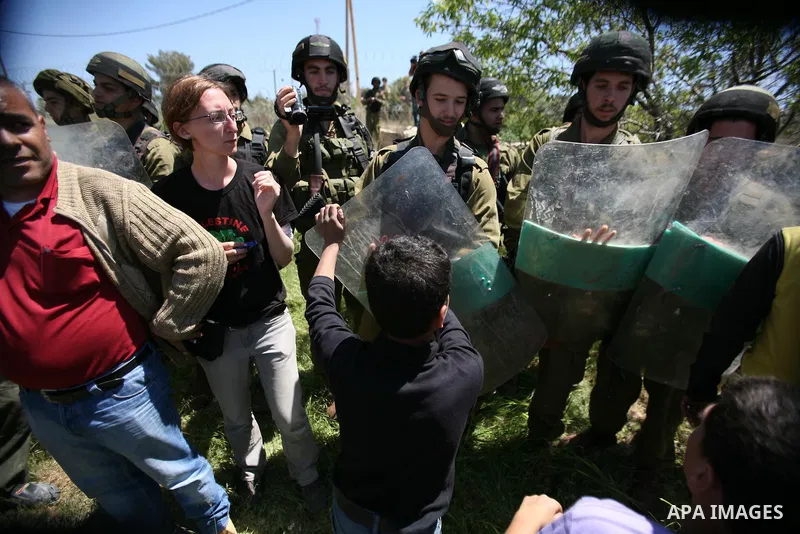 Israeli soldiers scuffle with Palestinian protesters during the weekly demonstration against settlement in the West Bank village Beit Ommar near Hebron.on April 21, 2012. Photo by Mamoun Wazwaz
