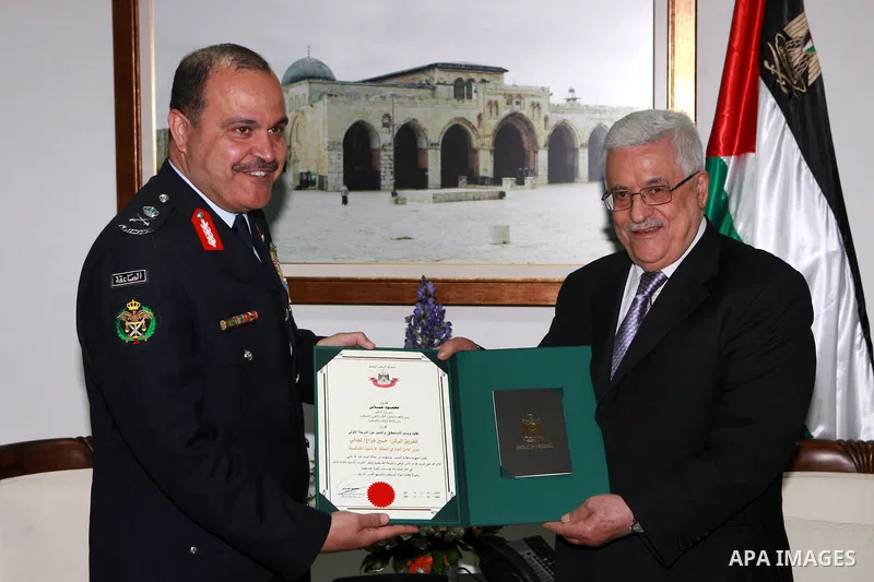Palestinian President, Mahmoud Abbas (Abu Mazen), confers the Director of Public Security of Jordan the Order of Merit and Excellence, in the West bank City of Ramallah on April 21, 2012. Photo by Thaer Ganaim