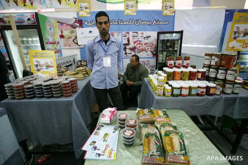 Palestinians participate in the opening of an exhibition of national products at the Islamic University in Gaza city on April 22, 2012. Photo by Naaman Omar
