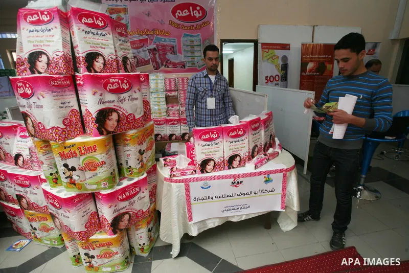 Palestinians participate in the opening of an exhibition of national products at the Islamic University in Gaza city on April 22, 2012. Photo by Naaman Omar