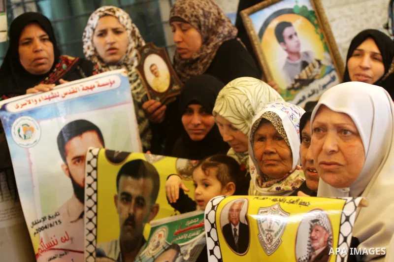 Palestinian women shout slogans during a demonstration for the release of Palestinian prisoners held in Israeli jails outside the Red Cross offices in Gaza City on April 23, 2012. At least 1,350 Palestinian prisoners bei...