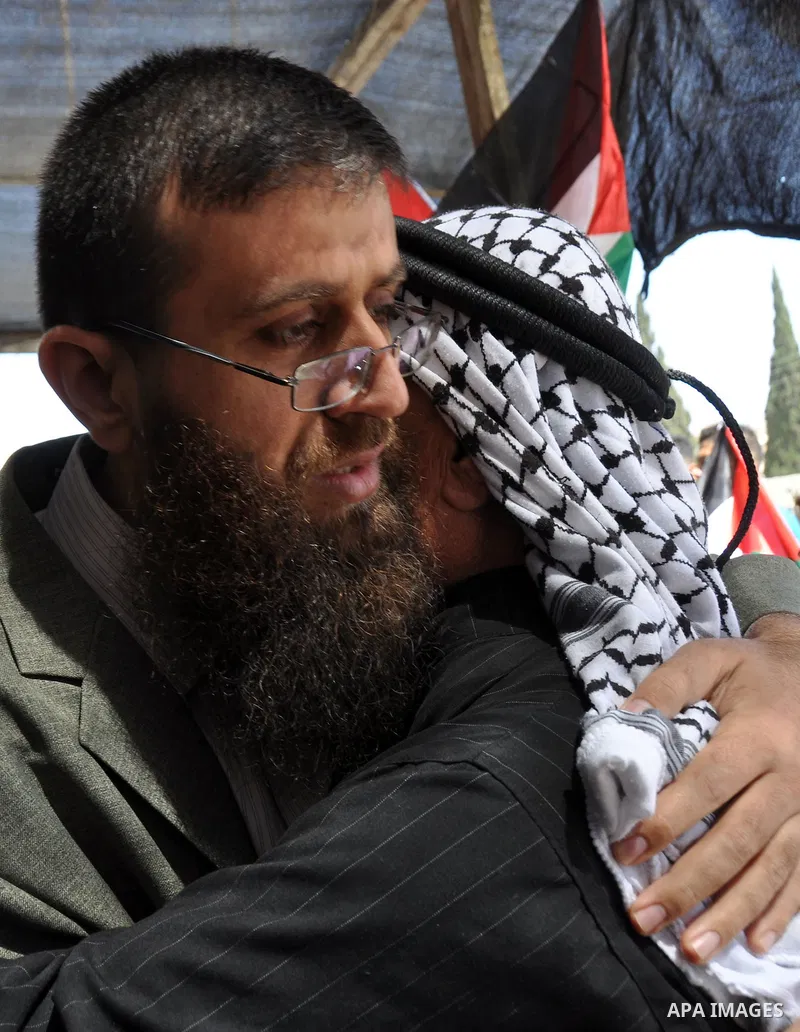 Palestinian Khader Adnan, a senior member of Islamic Jihad, who didn't eat for 66 days, was set to be freed later as part of a deal reached with Israel, is greeted by Palestinians during a protest calling for the release...
