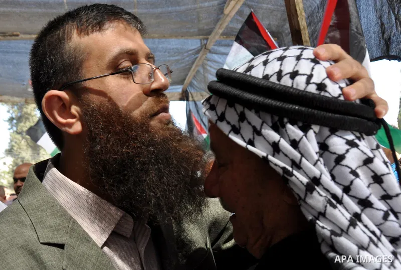 Palestinian Khader Adnan, a senior member of Islamic Jihad, who didn't eat for 66 days, was set to be freed later as part of a deal reached with Israel, is greeted by Palestinians during a protest calling for the release...