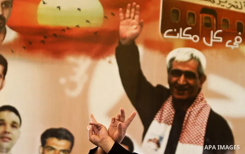 Palestinians hold up portraits of relatives jailed in Israeli prisons as they protest to demand for their release during a demonstration for the release of Palestinian prisoners held in Israeli jails outside the Red Cros...