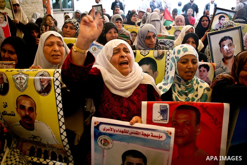 Palestinian women shout slogans during a demonstration for the release of Palestinian prisoners held in Israeli jails outside the Red Cross offices in Gaza City on April 23, 2012. At least 1,350 Palestinian prisoners bei...