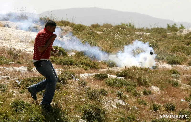 Israeli soldiers fire tear gas at Palestinian students during clashes near their school at Oref Village near the West Bank City of Nablus on 23 April 2012 .Israeli settlers from Jewish settlement of Yetshar attacked the...
