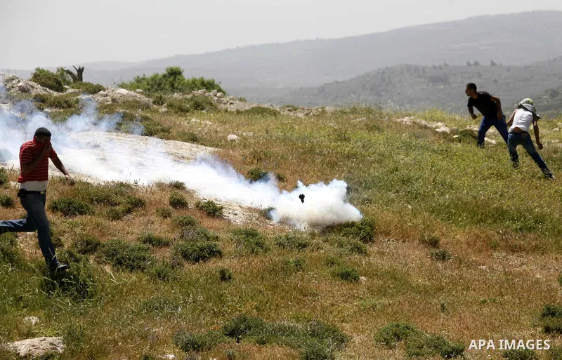 Israeli soldiers fire tear gas at Palestinian students during clashes near their school at Oref Village near the West Bank City of Nablus on 23 April 2012 .Israeli settlers from Jewish settlement of Yetshar attacked the...