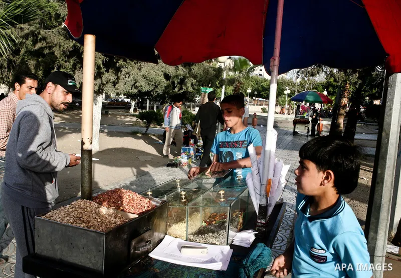 A Palestinian vendor sells nuts in a garden in Gaza city, 23 April 2012. With high rates of unemployment in Gaza strip. Photo by Ali Jadallah