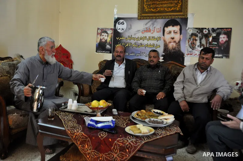 The father of former Palestinian hunger strike prisoner Khader Adnan, a senior member of Islamic Jihad who was jailed in Israel, sits with relatives at his house in the village of Arraba near the northern city of Jenin,...