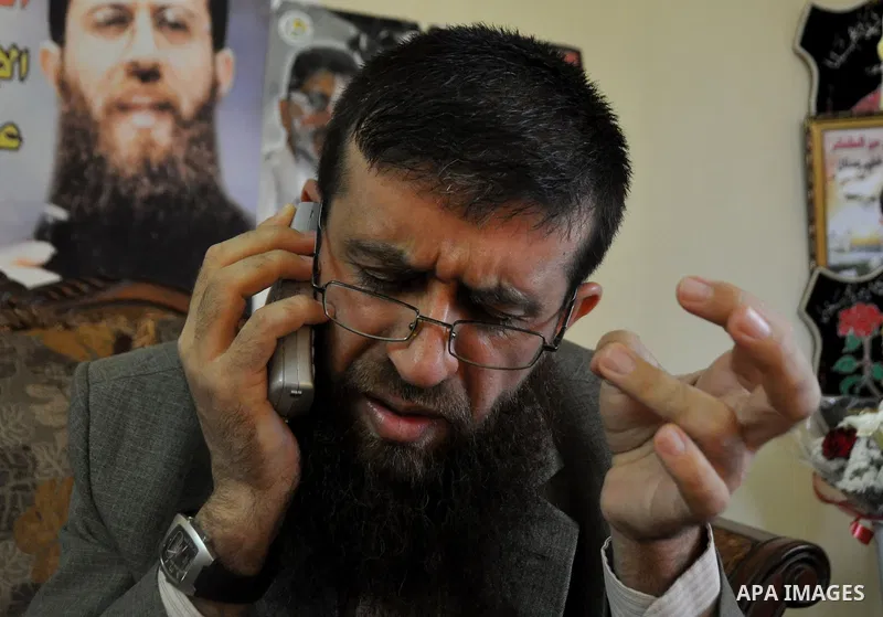 Former Palestinian hunger strike prisoner Khader Adnan, a senior member of Islamic Jihad who was jailed in Israel, uses his mobile at his house in the village of Arraba near the northern city of Jenin, in the Israeli occ...
