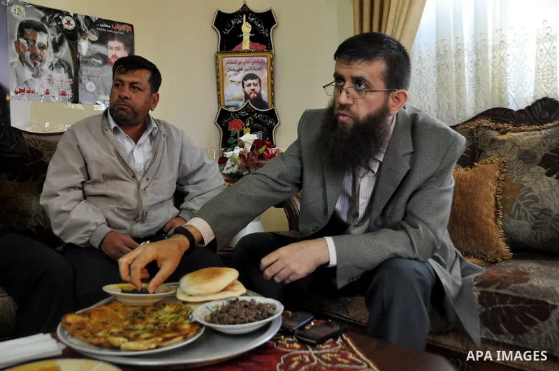 Former Palestinian hunger strike prisoner Khader Adnan, a senior member of Islamic Jihad who was jailed in Israel, eats food at his house in the village of Arraba near the northern city of Jenin, in the Israeli occupied...