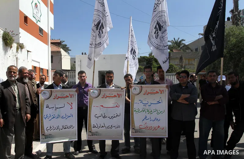 Palestinians of the Al-Ahrar Brigades, take part a protest calling for the release of Palestinian prisoners held in Israeli jails outside the Legislative Council in Gaza City on April 24, 2012 in solidarity with Palestin...