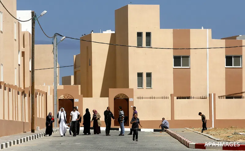 Palestinians take part a ceremony distributing new homes in Khan Younis in the southern Gaza Strip April 24, 2012. Palestinians, whose houses were destroyed during Israeli military operations in 2004 and 2005, received a...