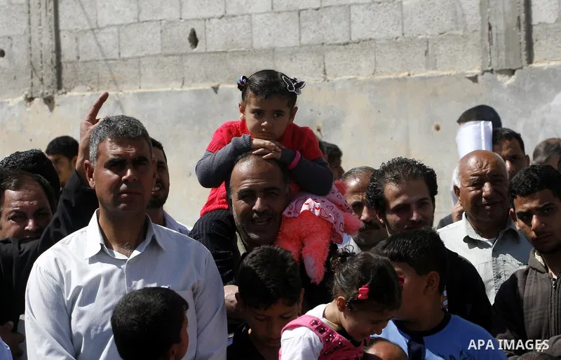 Palestinians take part a ceremony distributing new homes in Khan Younis in the southern Gaza Strip April 24, 2012. Palestinians, whose houses were destroyed during Israeli military operations in 2004 and 2005, received a...