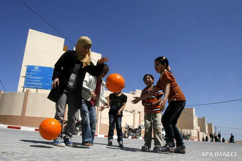 Palestinians Children play during a ceremony distributing new homes in Khan Younis in the southern Gaza Strip April 24, 2012. Palestinians, whose houses were destroyed during Israeli military operations in 2004 and 2005,...