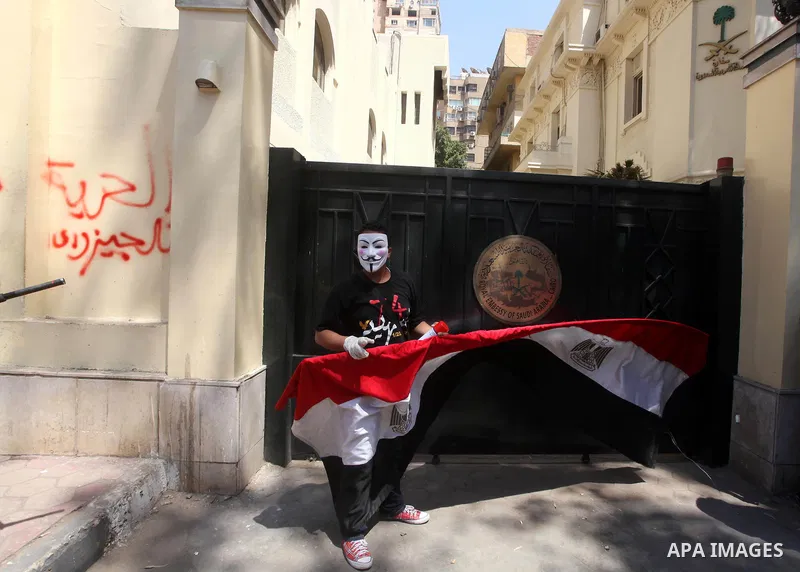 An Egyptian protester wears a mask during a demonstration in front of Saudi Arabian embassy in Cairo on April 24, 2012 calling for the release of the Egyptians who have been detained in the kingdom, including Ahmed al-Gi...