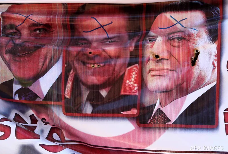 Egyptian demonstrators holding up portraits during a protest at Tahrir Square in Cairo, Egypt on April 25, 2012. Several thousand Egyptians are protesting against the country's military rulers. Photo by Ashraf Amra