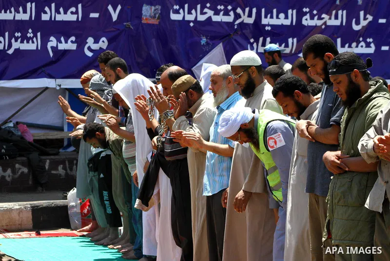 Egyptian demonstrators attend pray during a protest at Tahrir Square in Cairo, Egypt on April 25, 2012. Several thousand Egyptians are protesting against the country's military rulers. Photo by Ashraf Amra