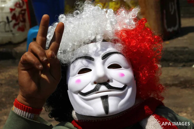 Egyptian masked man chants slogans during a protest at Tahrir Square in Cairo, Egypt on April 25, 2012. Several thousand Egyptians are protesting against the country's military rulers. Photo by Ashraf Amra