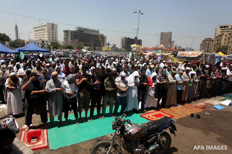 Egyptian demonstrators attend pray during a protest at Tahrir Square in Cairo, Egypt on April 25, 2012. Several thousand Egyptians are protesting against the country's military rulers. Photo by Ashraf Amra