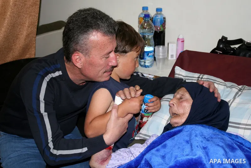 Palestinian activist Bassem Tamimi with his mother in a hospital in Ramallah on April 25, 2012, after a military court released him on bail on April 24, ahead of the verdict in his trial on charges of organising popular...