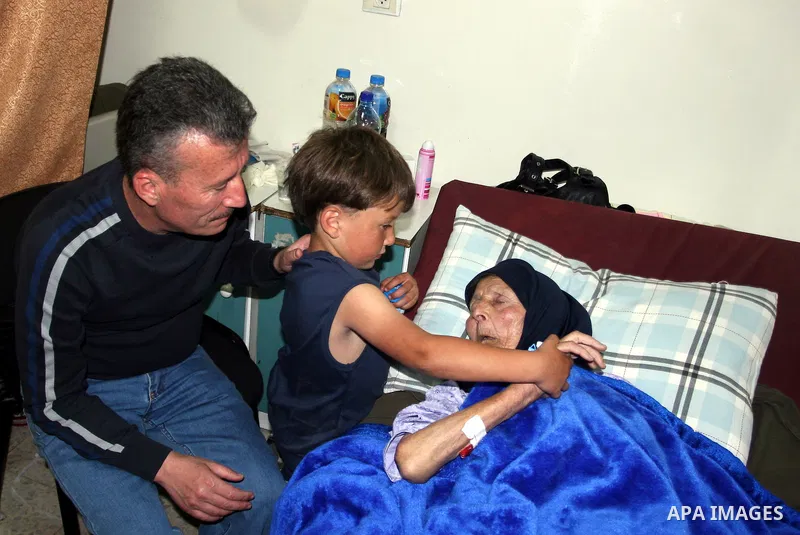 Palestinian activist Bassem Tamimi with his mother in a hospital in Ramallah on April 25, 2012, after a military court released him on bail on April 24, ahead of the verdict in his trial on charges of organising popular...