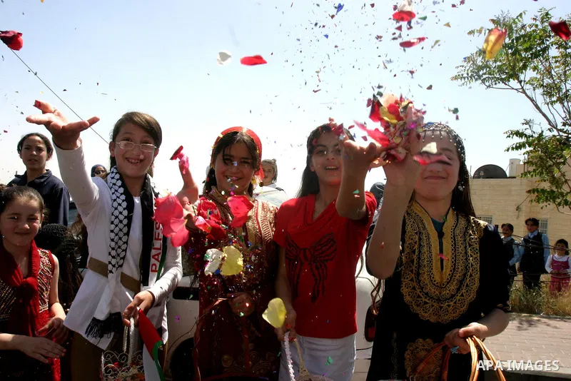 Palestinians celebrate the release of Tawfiq Iwisaat following his release from Israeli jail after 18 years of imprisonment in the Arab east Jerusalem neighbourhood of Jabal Mukaber on April 25, 2012. Photo by Mahfouz Ab...
