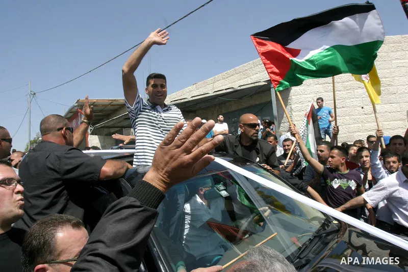 Palestinians celebrate the release of Tawfiq Iwisaat following his release from Israeli jail after 18 years of imprisonment in the Arab east Jerusalem neighbourhood of Jabal Mukaber on April 25, 2012. Photo by Mahfouz Ab...