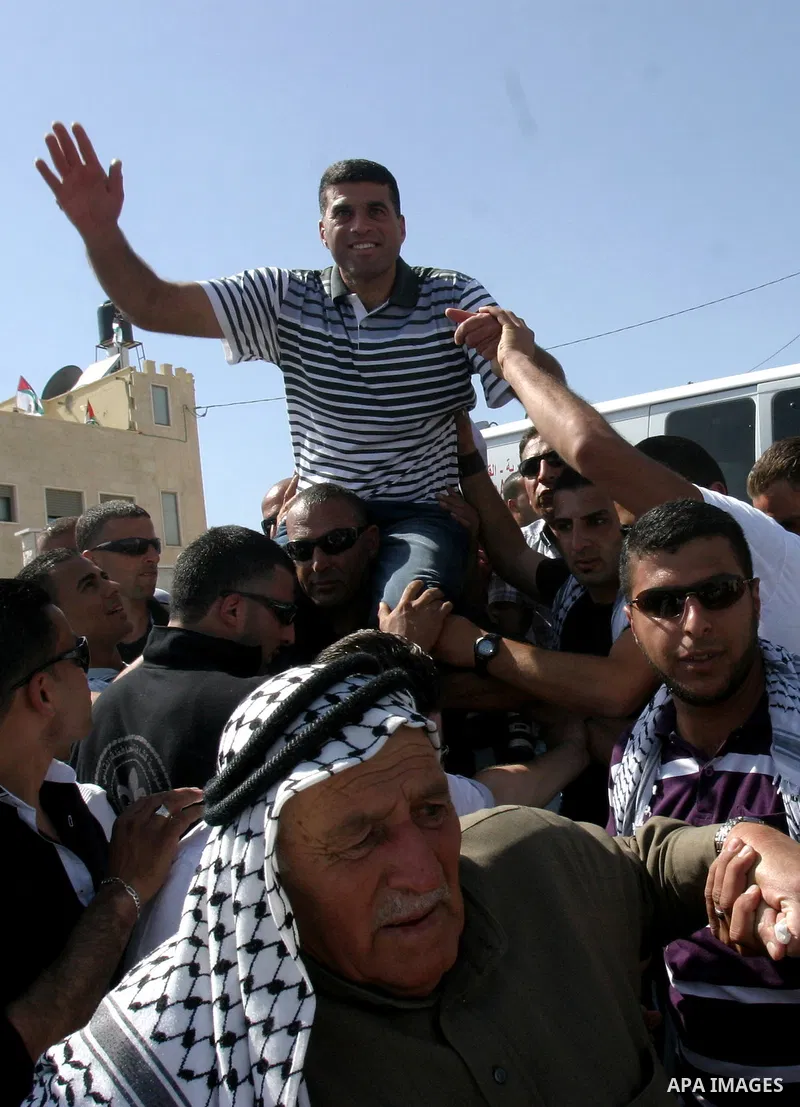 Palestinians celebrate the release of Tawfiq Iwisaat following his release from Israeli jail after 18 years of imprisonment in the Arab east Jerusalem neighbourhood of Jabal Mukaber on April 25, 2012. Photo by Mahfouz Ab...