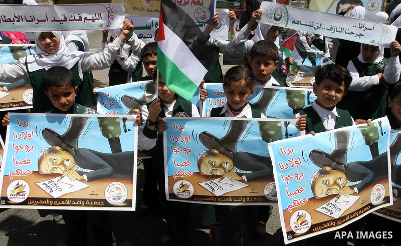 Palestinian students shout slogans during a demonstration for the release of Palestinian prisoners held in Israeli jails in front of the Red Cross offices in Gaza City on April 26, 2012. At least 1,350 Palestinian prison...
