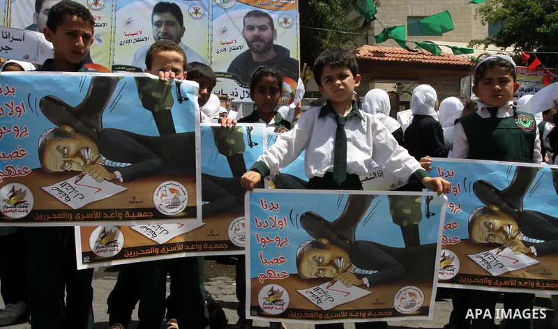 Palestinian students shout slogans during a demonstration for the release of Palestinian prisoners held in Israeli jails in front of the Red Cross offices in Gaza City on April 26, 2012. At least 1,350 Palestinian prison...