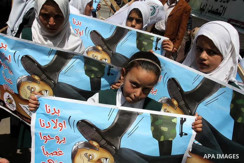 Palestinian students shout slogans during a demonstration for the release of Palestinian prisoners held in Israeli jails in front of the Red Cross offices in Gaza City on April 26, 2012. At least 1,350 Palestinian prison...