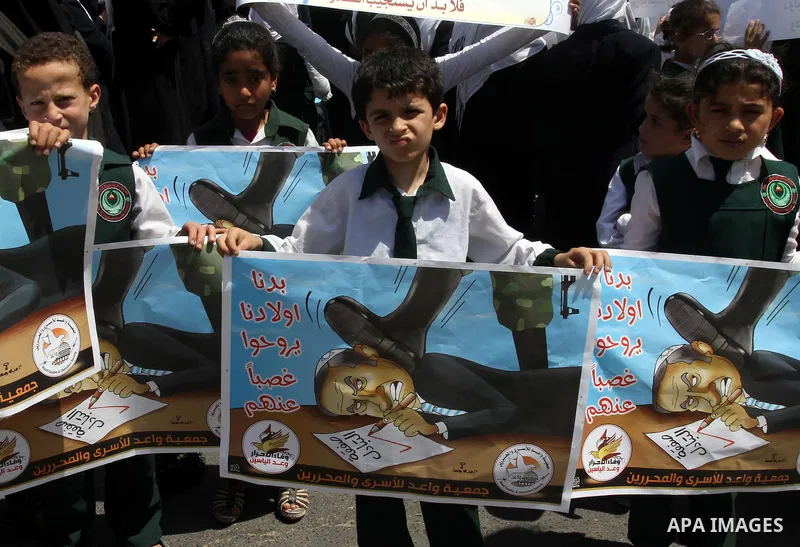 Palestinian students shout slogans during a demonstration for the release of Palestinian prisoners held in Israeli jails in front of the Red Cross offices in Gaza City on April 26, 2012. At least 1,350 Palestinian prison...