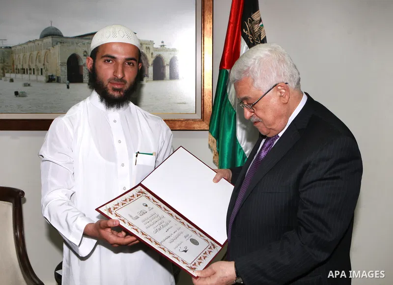Palestinian President, Mahmoud Abbas (Abu Mazen), meets with Daoud Abayat first place winner in the Islamic world in the Contest of memorizing the Holy Quran, in the West bank City of Ramallah, on April 26, 2012. Photo b...