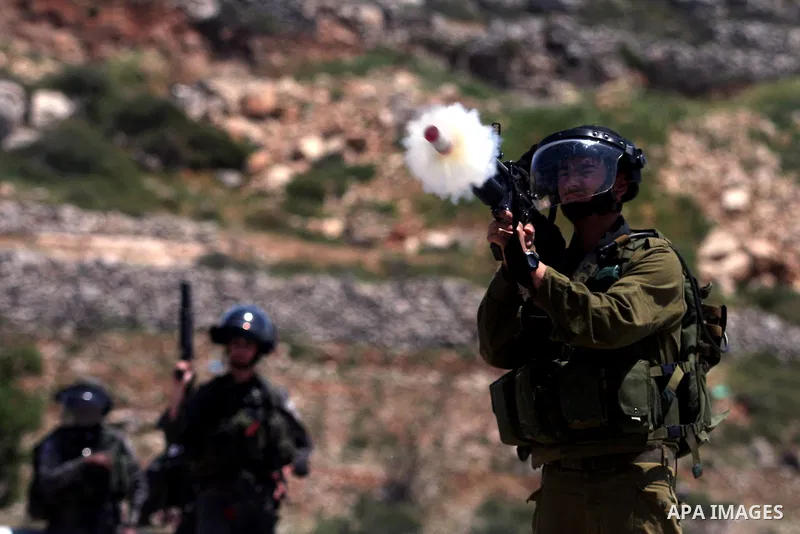 Israeli soldiers fire tear gas during clashes at the Bitwonia crossing outside the Israeli military prison of Ofer, on Israel's 64th Independence Day, 26 April 2012. Palestinians staged their protest near the Ofer prison...