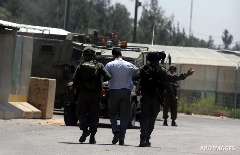 Israeli police detain a Palestinian during a rally calling for the release of Palestinian prisoners jailed in Israel, near the West Bank city of Ramallah, Thursday, April 26, 2012. Photo by Issam Rimawi