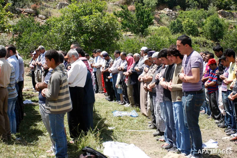 Palestinians pray during a protest against land confiscation by nearby Jewish settlements, Wadi Qana, in the West Bank village Deir Istia , Friday, April 27, 2012 . Photo by Wagdi Eshtayah