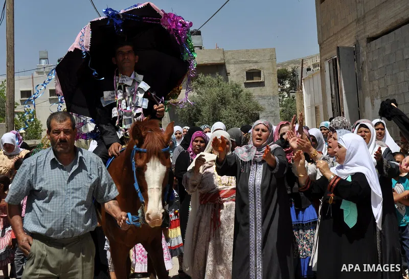 Relatives Palestinian groom Abbas Thawabteh, dancing during heritage wedding in the village of Azmut eastern city of Nablus in the West Bank,on 27 April 2012. Photo by Nedal Shtieh. Photo by Nedal Shtieh