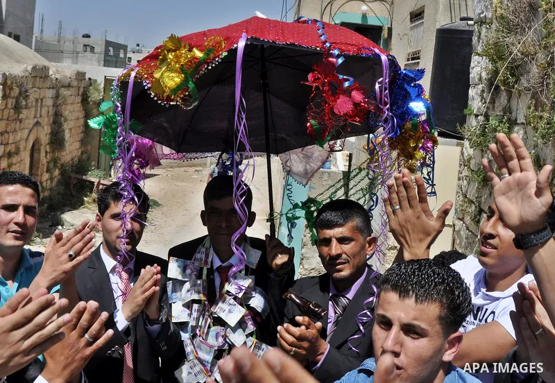 Relatives Palestinian groom Abbas Thawabteh, dancing during heritage wedding in the village of Azmut eastern city of Nablus in the West Bank,on 27 April 2012. Photo by Nedal Shtieh. Photo by Nedal Shtieh