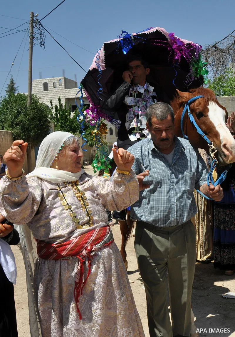 Relatives Palestinian groom Abbas Thawabteh, dancing during heritage wedding in the village of Azmut eastern city of Nablus in the West Bank,on 27 April 2012. Photo by Nedal Shtieh. Photo by Nedal Shtieh